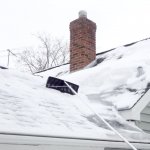 roof rake on snow-covered roof